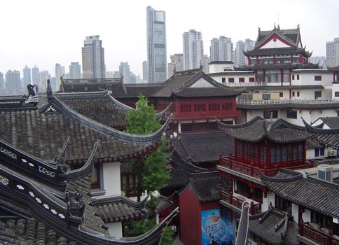 Rooftops of Old Shanghai and Modern Shanghai Office Towers.