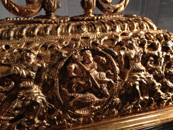 Detail of gilded basket top of a bracket clock by Merriman, with St George and the Dragon centre. Raffety Antique Clocks