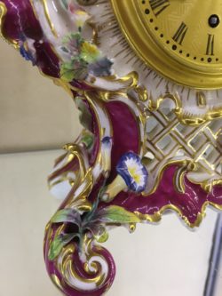 Detail of scrolled foot, with gilding, finely modelled foliage and flowers.